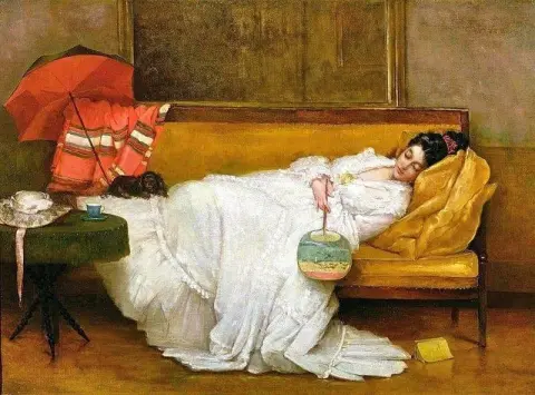 Girl In A White Dress Resting On A Sofa